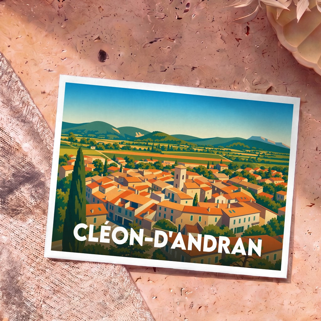 Carte postale souvenir de la ville de Cléon-d'Andran illustrant un panorama coloré du village provençal au pied des montagnes.