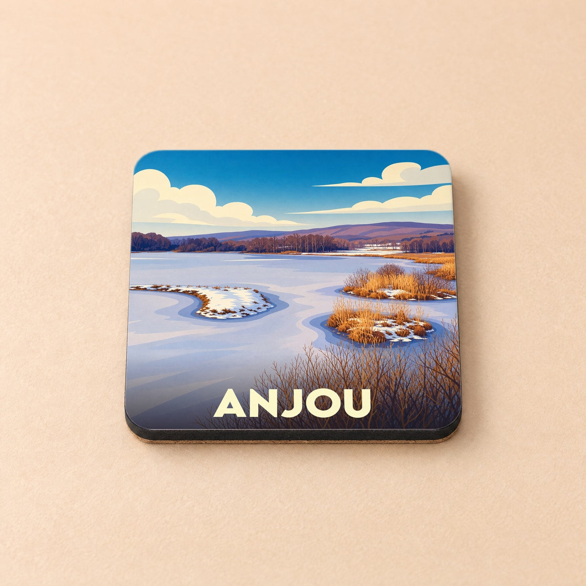 Dessous de verre souvenir de la ville d'Anjou illustrant un paysage de rivière hivernal au style graphique épuré.
