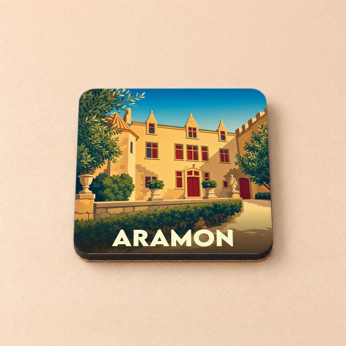 Dessous de verre souvenir de la ville d'Aramon avec une illustration stylisée de son château.