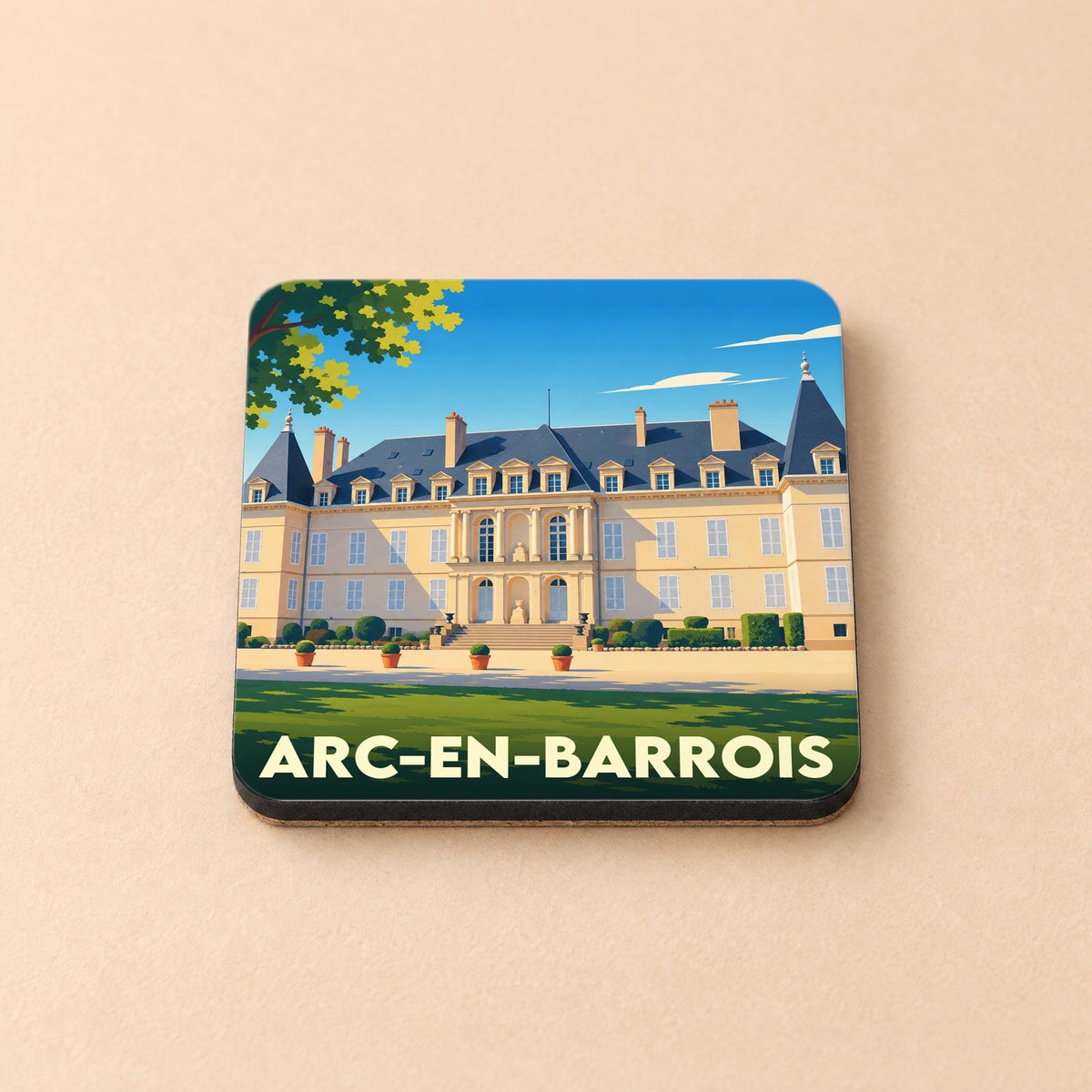 Dessous de verre souvenir de la ville d'Arc-en-Barrois illustré par un château stylisé sous un ciel bleu.