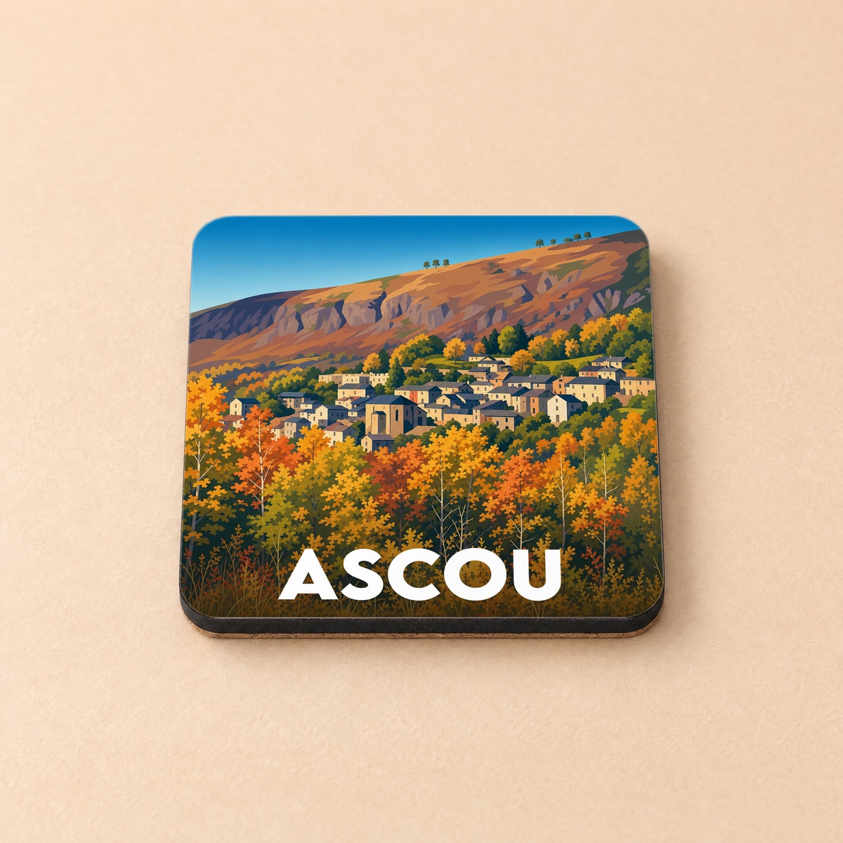 Dessous de verre souvenir de la ville d'Ascou avec une illustration stylisée de son paysage automnal.