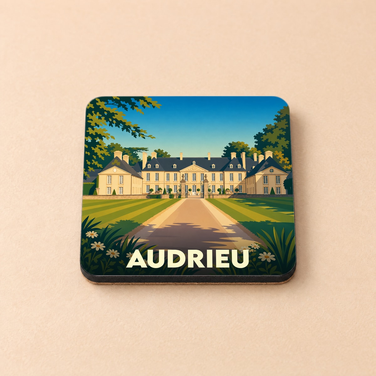 Dessous de verre souvenir de la ville de Audrieu avec une illustration stylisée d'un château.