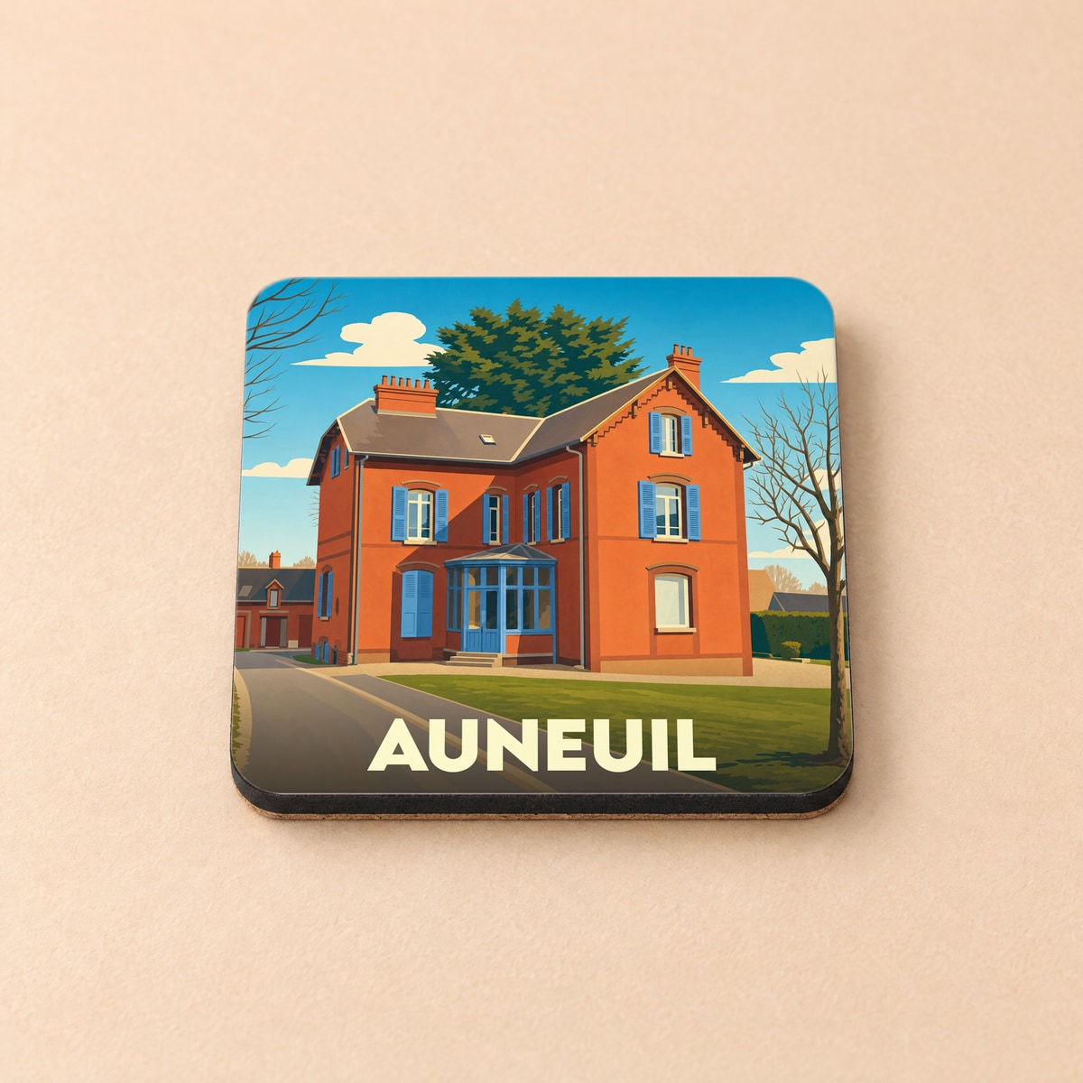 Dessous de verre souvenir de la ville d'Auneuil avec une illustration stylisée d'une maison traditionnelle.