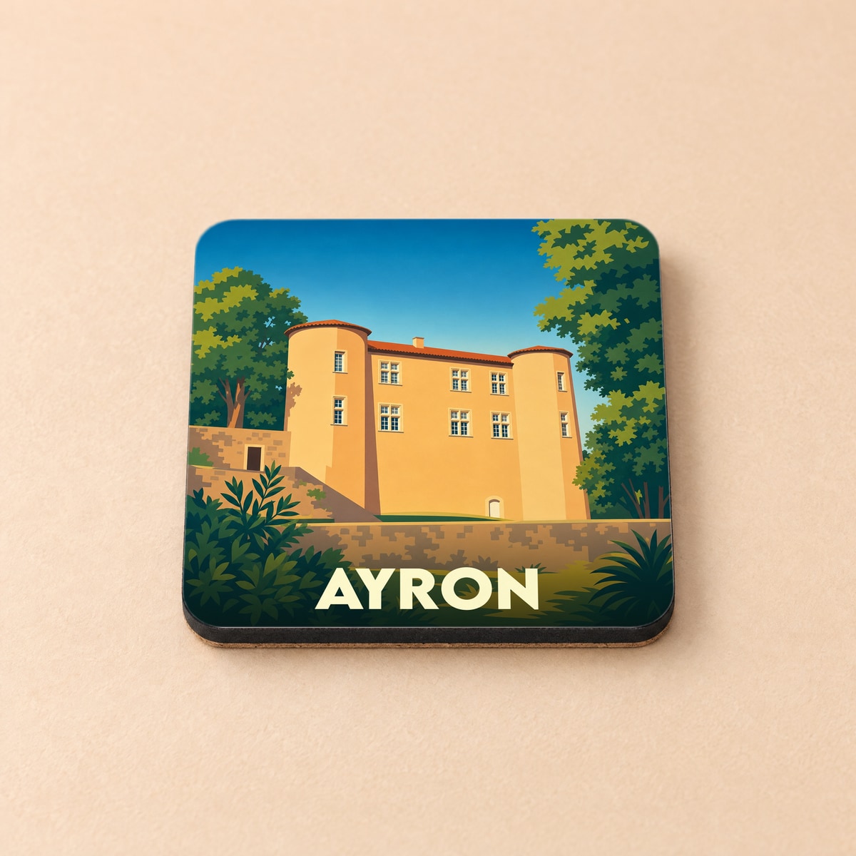 Dessous de verre souvenir de la ville d'Ayron avec une illustration stylisée de son château.