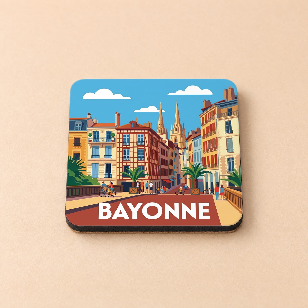 Dessous de verre souvenir de la ville de Bayonne avec une illustration stylisée et colorée de son architecture.