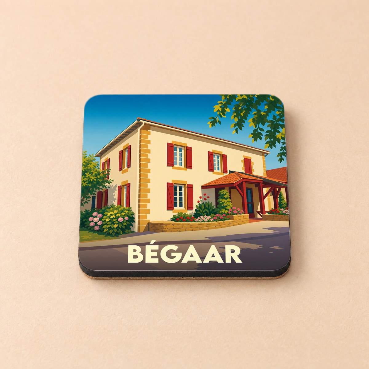 Dessous de verre souvenir de la ville de Bégaar avec une illustration stylisée d'une maison landaise.