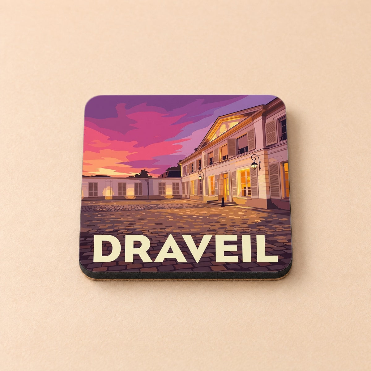 Dessous de verre souvenir de la ville de Draveil avec une illustration stylisée d'un château au coucher du soleil.
