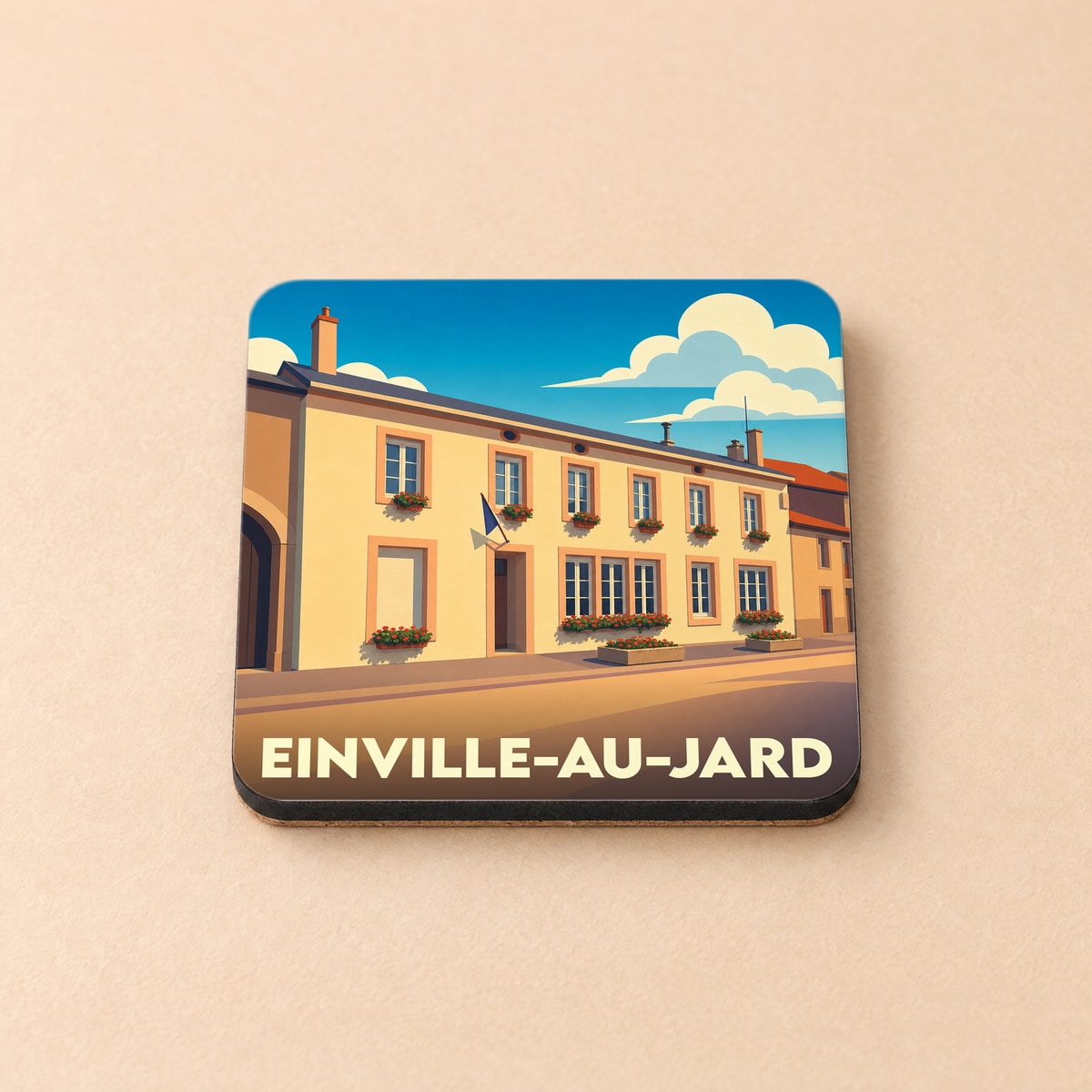 Dessous de verre souvenir de la ville d'Einville-au-Jard avec une illustration stylisée de sa mairie.