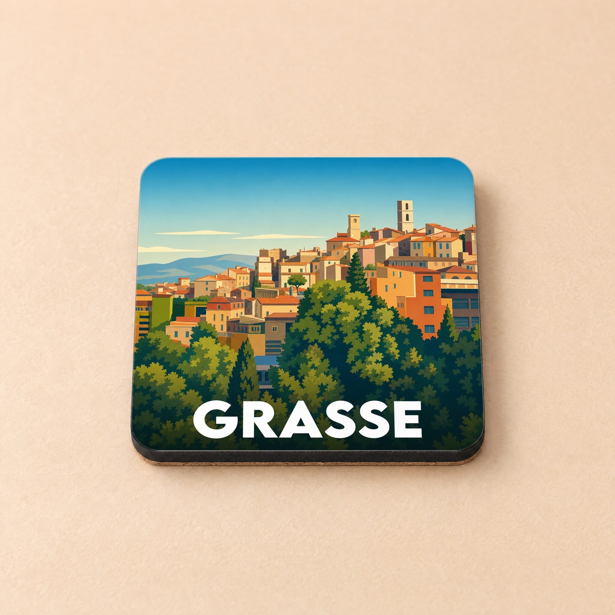 Dessous de verre souvenir de la ville de Grasse avec une illustration stylisée de ses maisons colorées et de sa végétation.