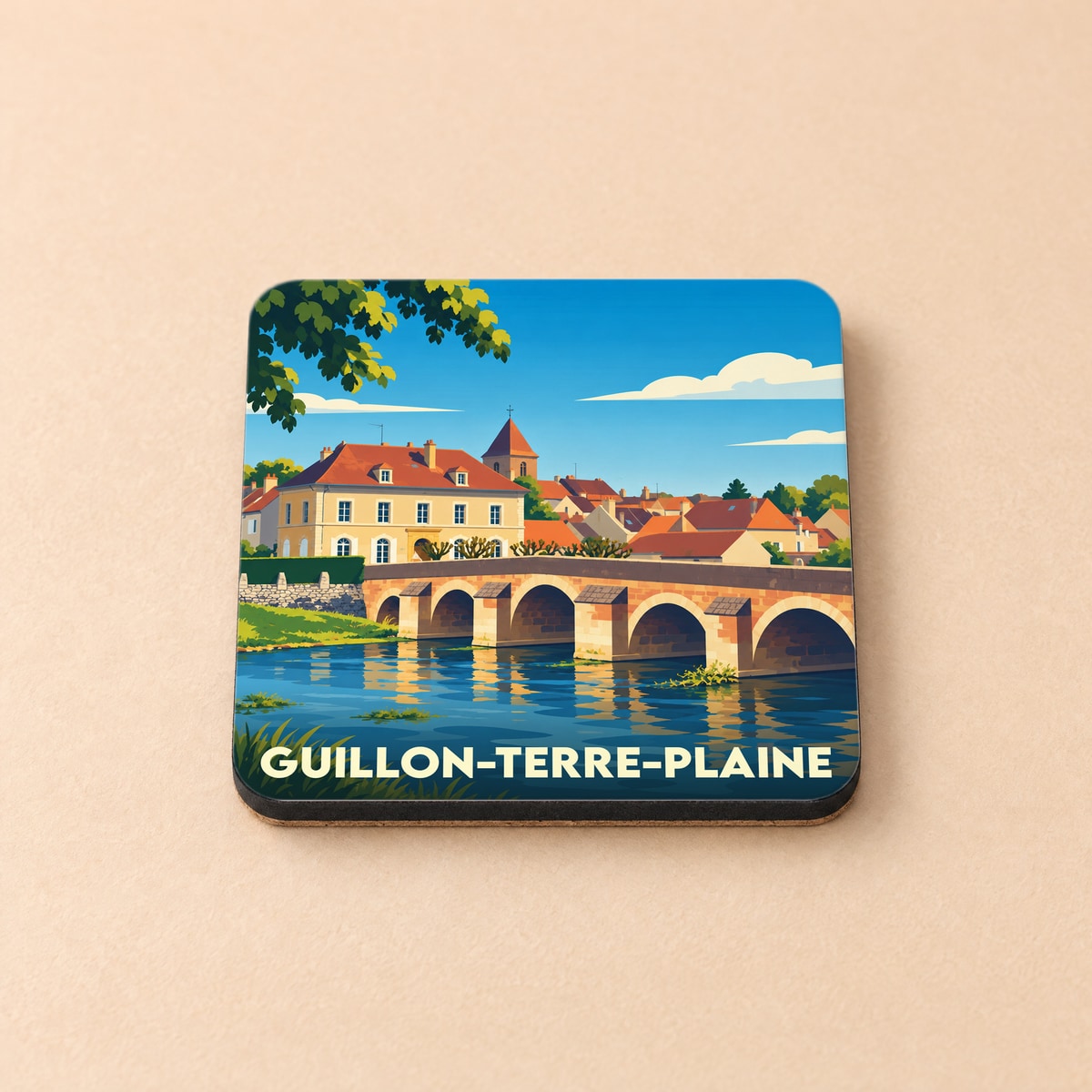 Dessous de verre souvenir de Guillon-Terre-Plaine avec une illustration stylisée d'un pont en pierre.