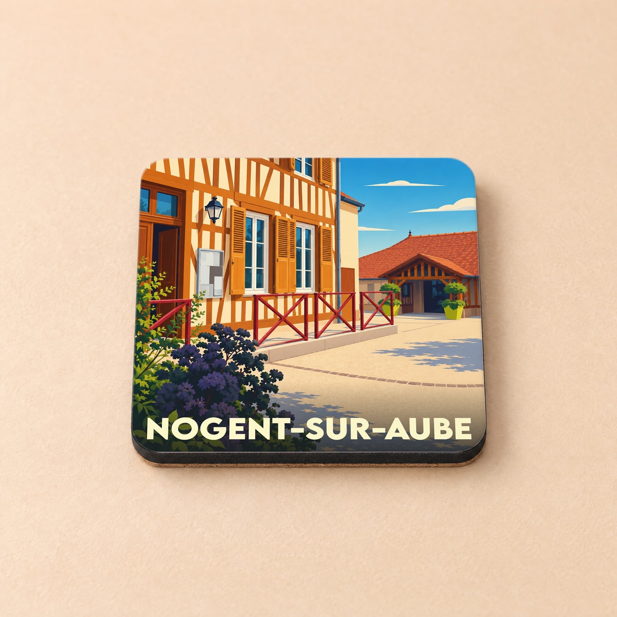 Dessous de verre souvenir de la ville de Nogent-sur-Aube avec une illustration stylisée d'une maison à colombages.