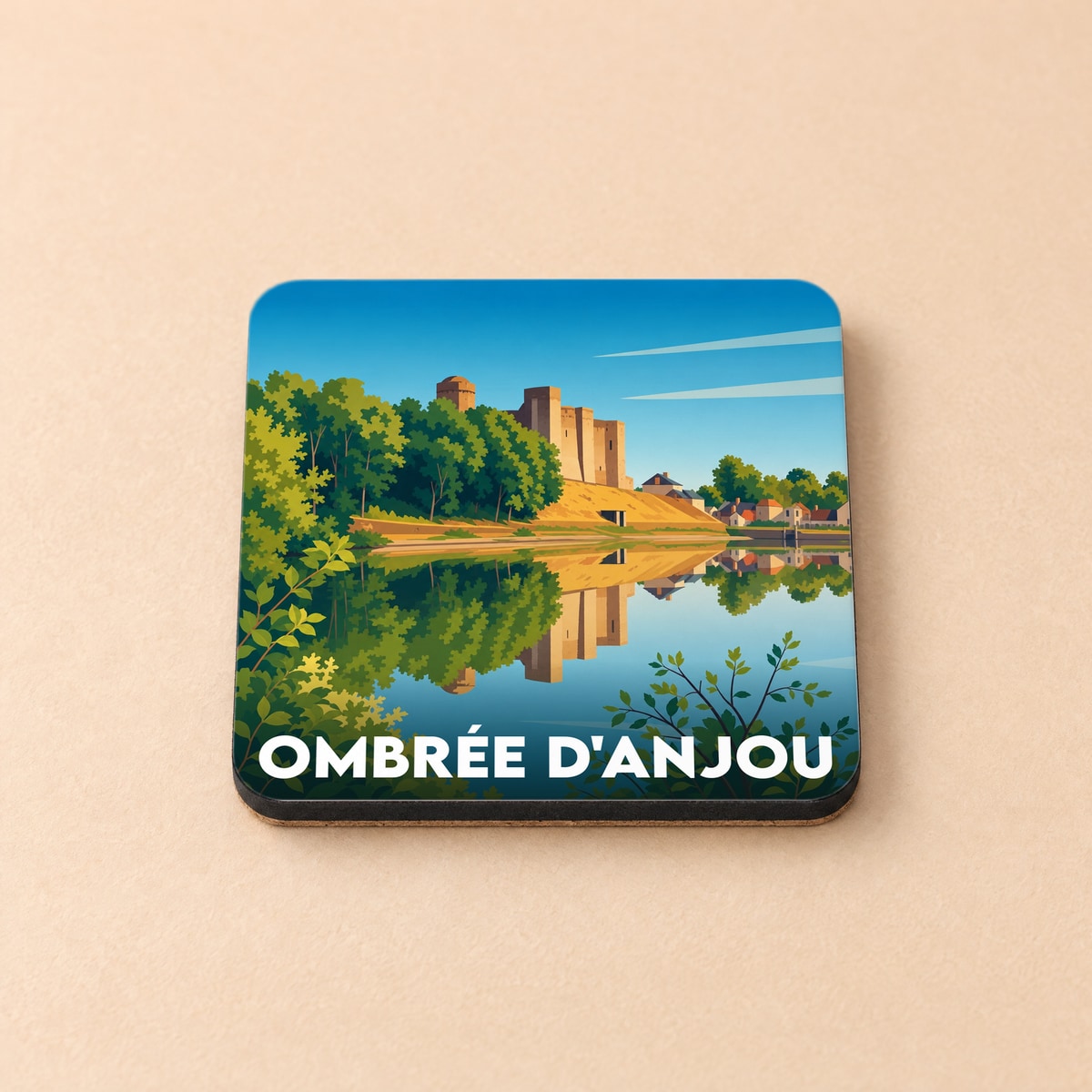 Dessous de verre souvenir de la ville d'Ombrée d'Anjou illustrant son château se reflétant dans l'eau.