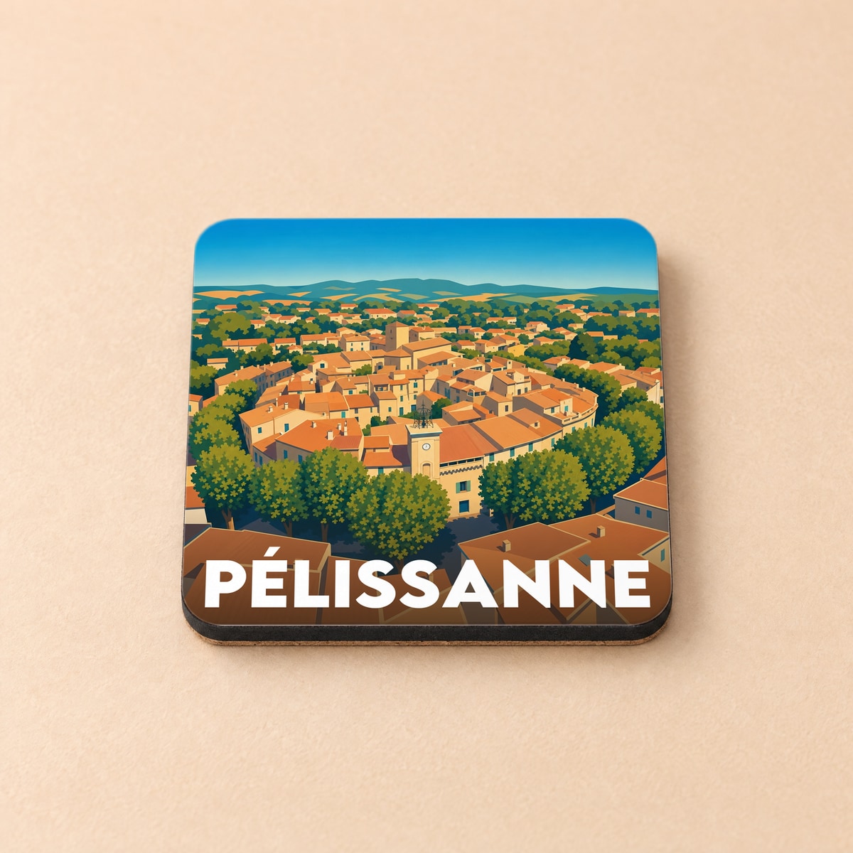 Dessous de verre souvenir de la ville de Pélissanne avec une illustration stylisée du village provençal.