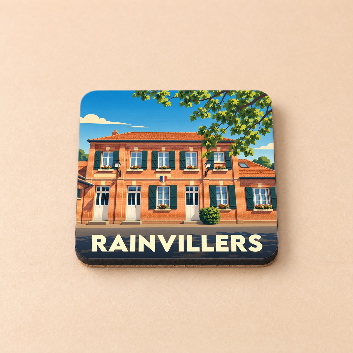Dessous de verre souvenir de la ville de Rainvillers avec une illustration stylisée d'un bâtiment en briques.