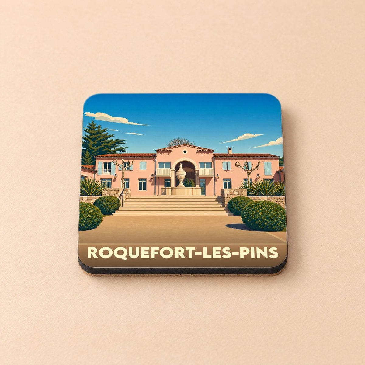 Dessous de verre souvenir de la ville de Roquefort-les-Pins avec une illustration stylisée.