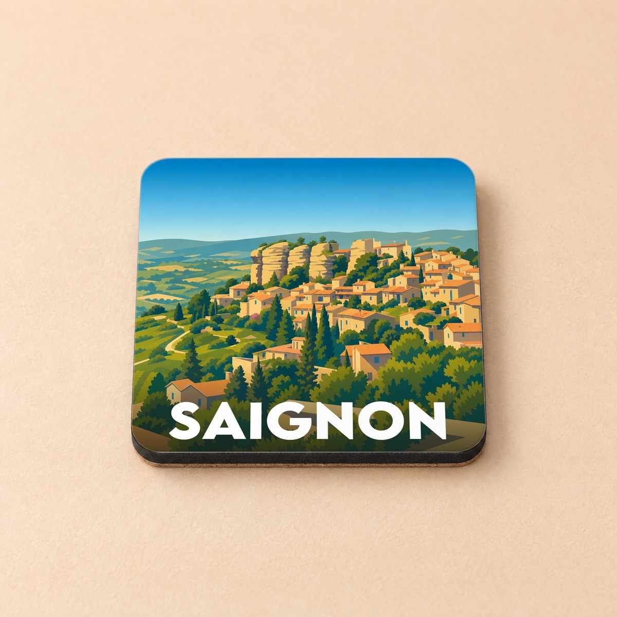 Dessous de verre souvenir de la ville de Saignon avec une illustration stylisée de ses maisons provençales.