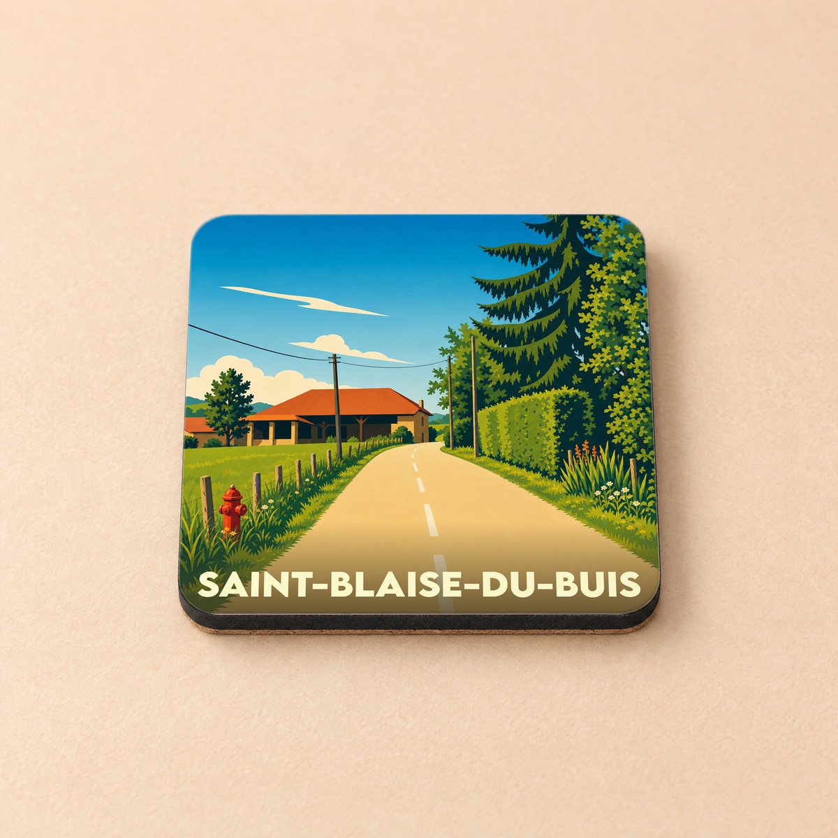 Dessous de verre souvenir de Saint-Blaise-du-Buis illustrant un paysage de campagne ensoleillé.