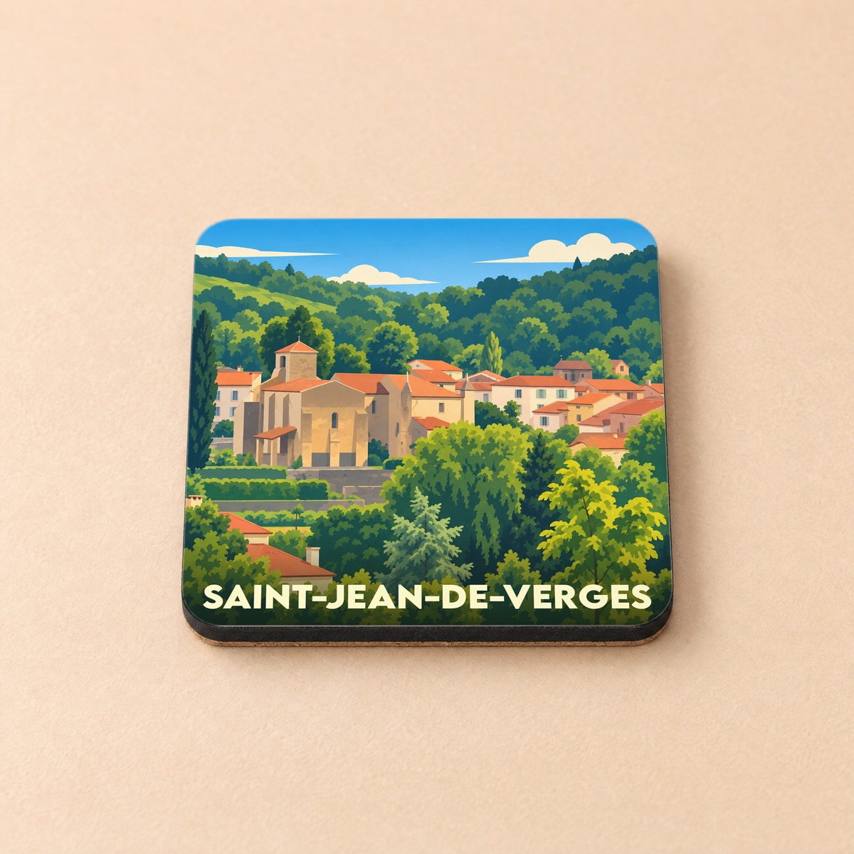 Dessous de verre souvenir de Saint-Jean-de-Verges avec une illustration stylisée du village et de son église.
