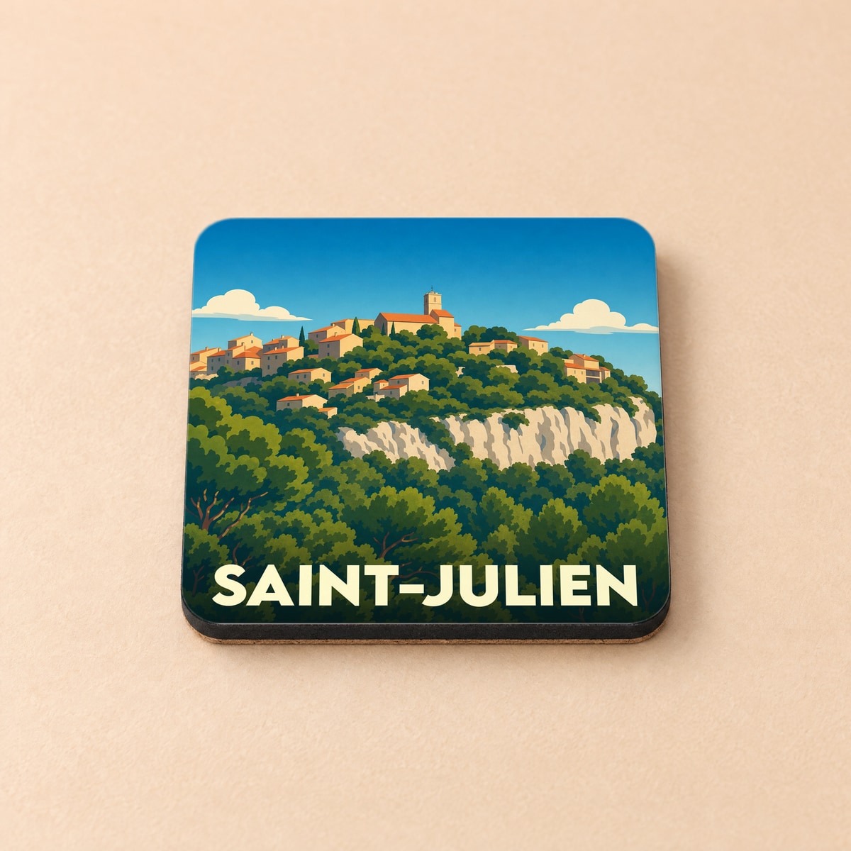 Dessous de verre souvenir de la ville de Saint-Julien avec une illustration stylisée d'un village perché.