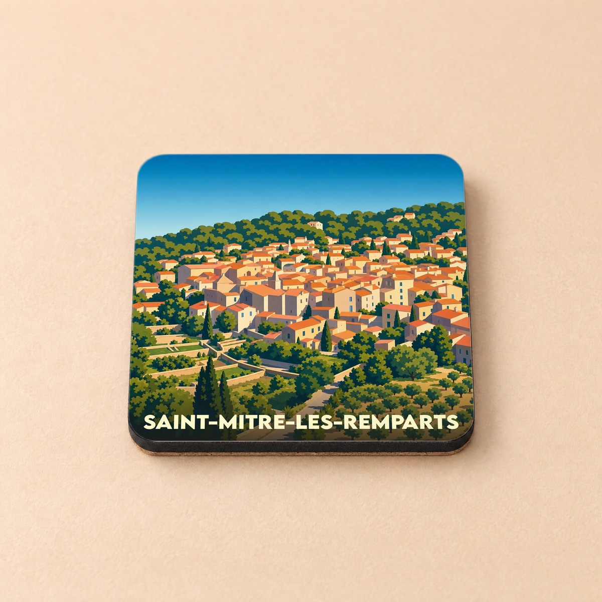 Dessous de verre souvenir de la ville de Saint-Mitre-les-Remparts avec une illustration stylisée de ses maisons provençales.
