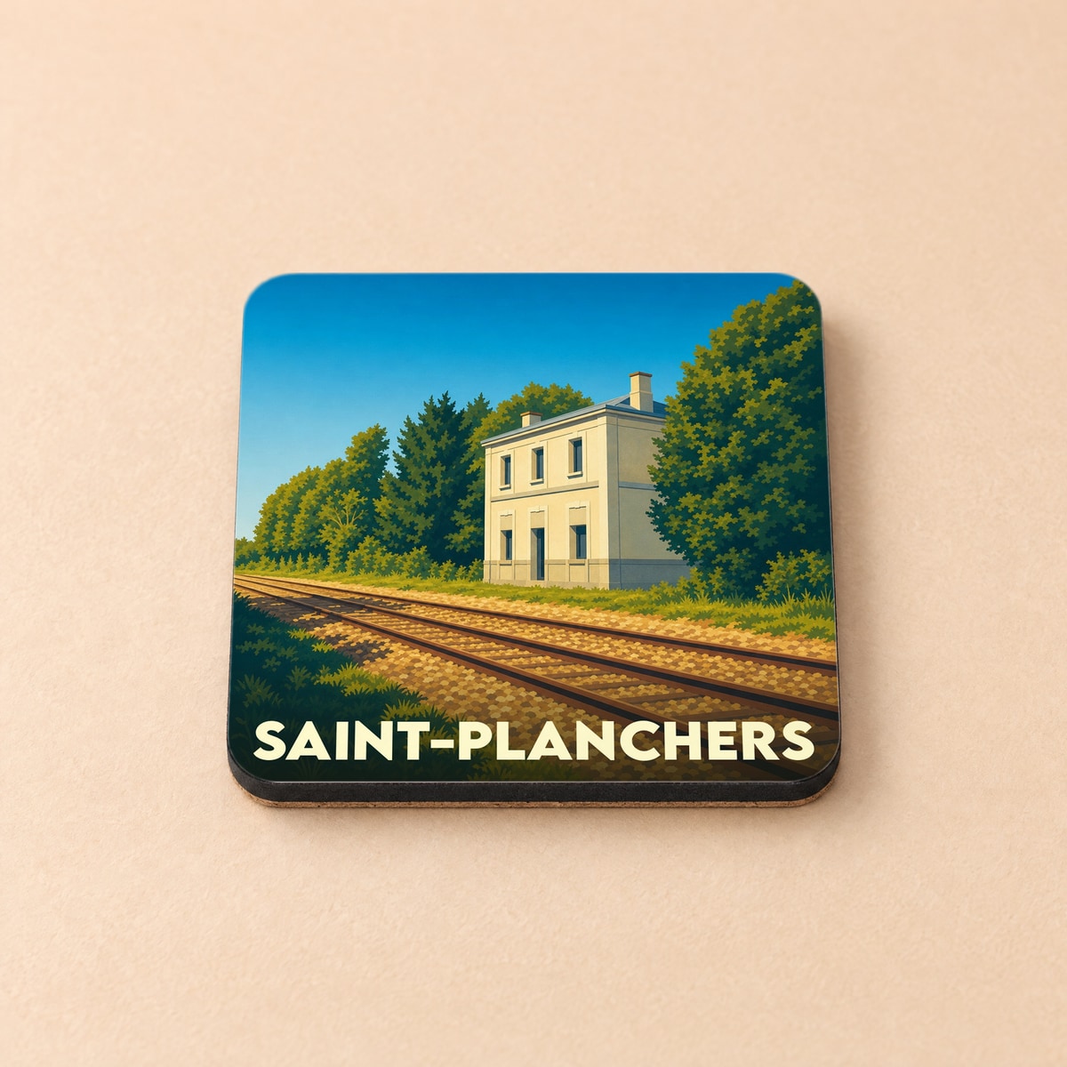 Dessous de verre souvenir de la ville de Saint-Planchers avec une illustration stylisée d'une gare et de rails.