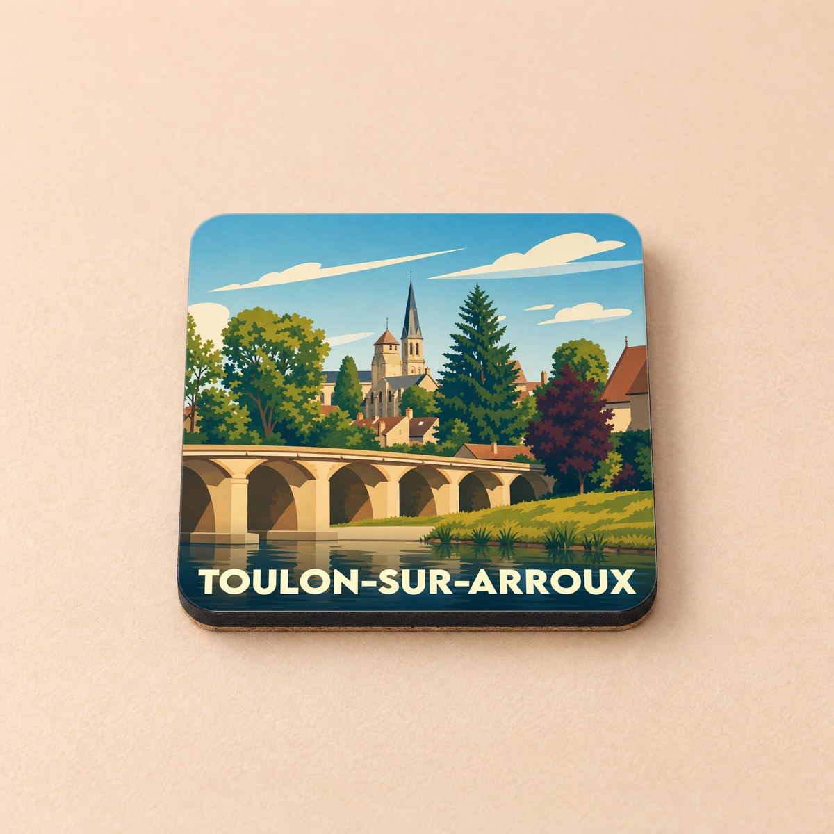 Dessous de verre souvenir de la ville de Toulon-sur-Arroux avec une illustration stylisée de son pont et de son église.