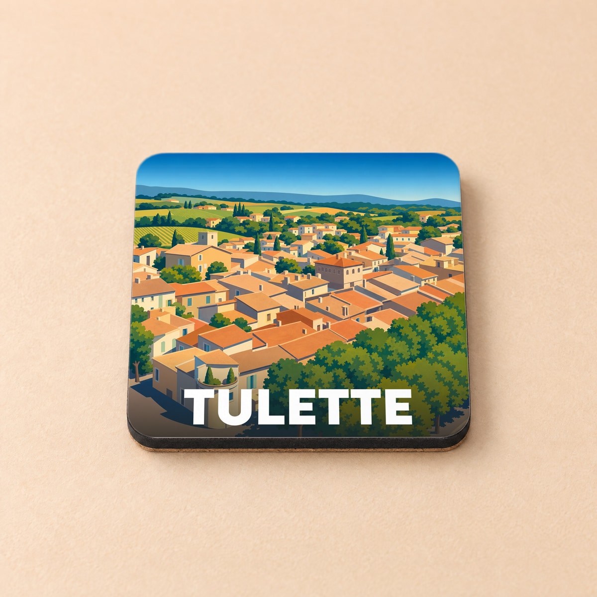 Dessous de verre souvenir de la ville de Tulette avec une illustration stylisée de ses toits provençaux.