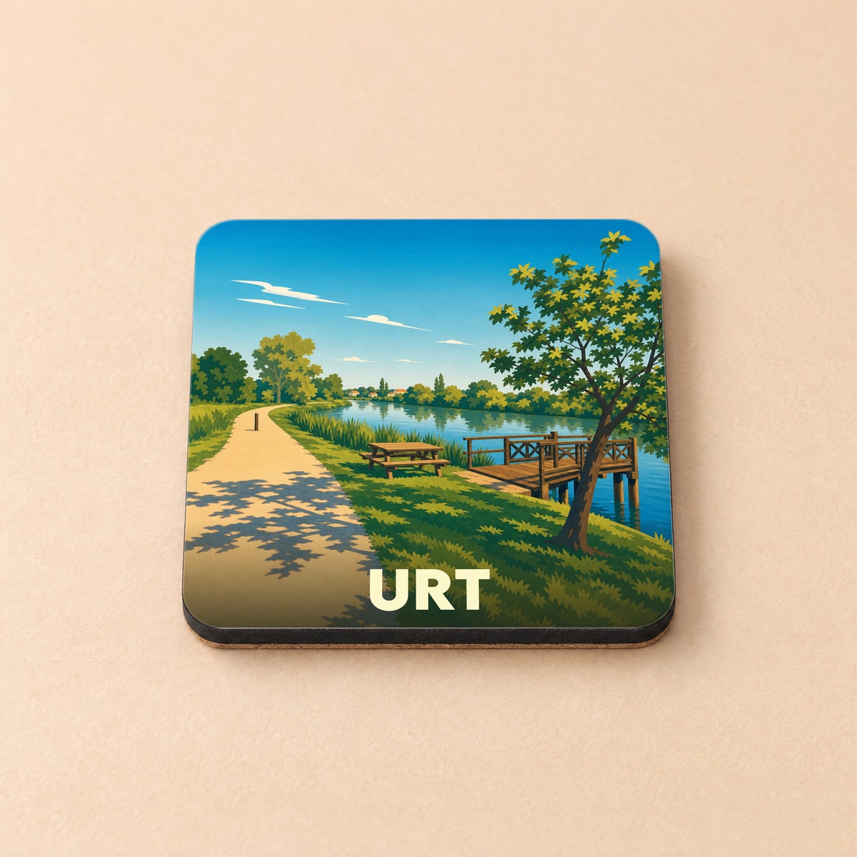 Dessous de verre souvenir de la ville de Urt avec une illustration stylisée d'un bord de rivière.