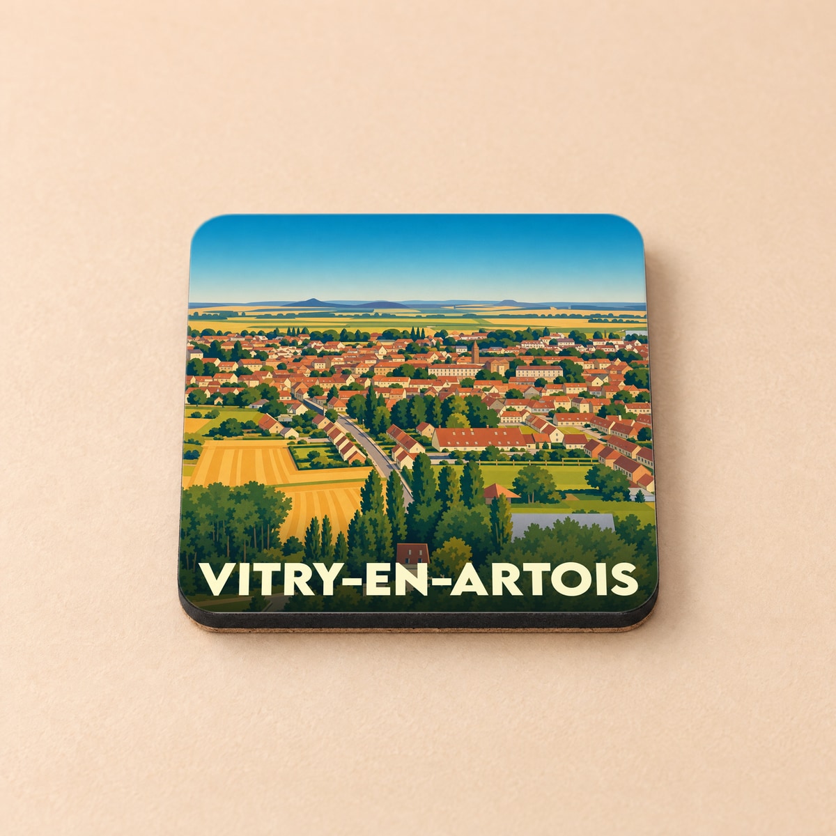 Dessous de verre souvenir de la ville de Vitry-en-Artois avec une illustration stylisée d'un paysage urbain et champêtre.