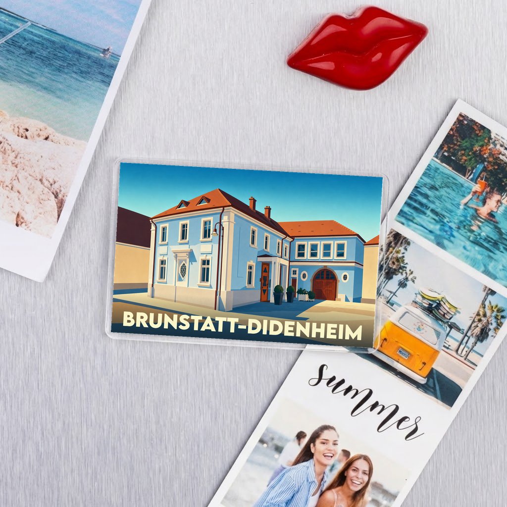 Magnet souvenir de la ville de Brunstatt-Didenheim avec une illustration stylisée d'un bâtiment bleu.