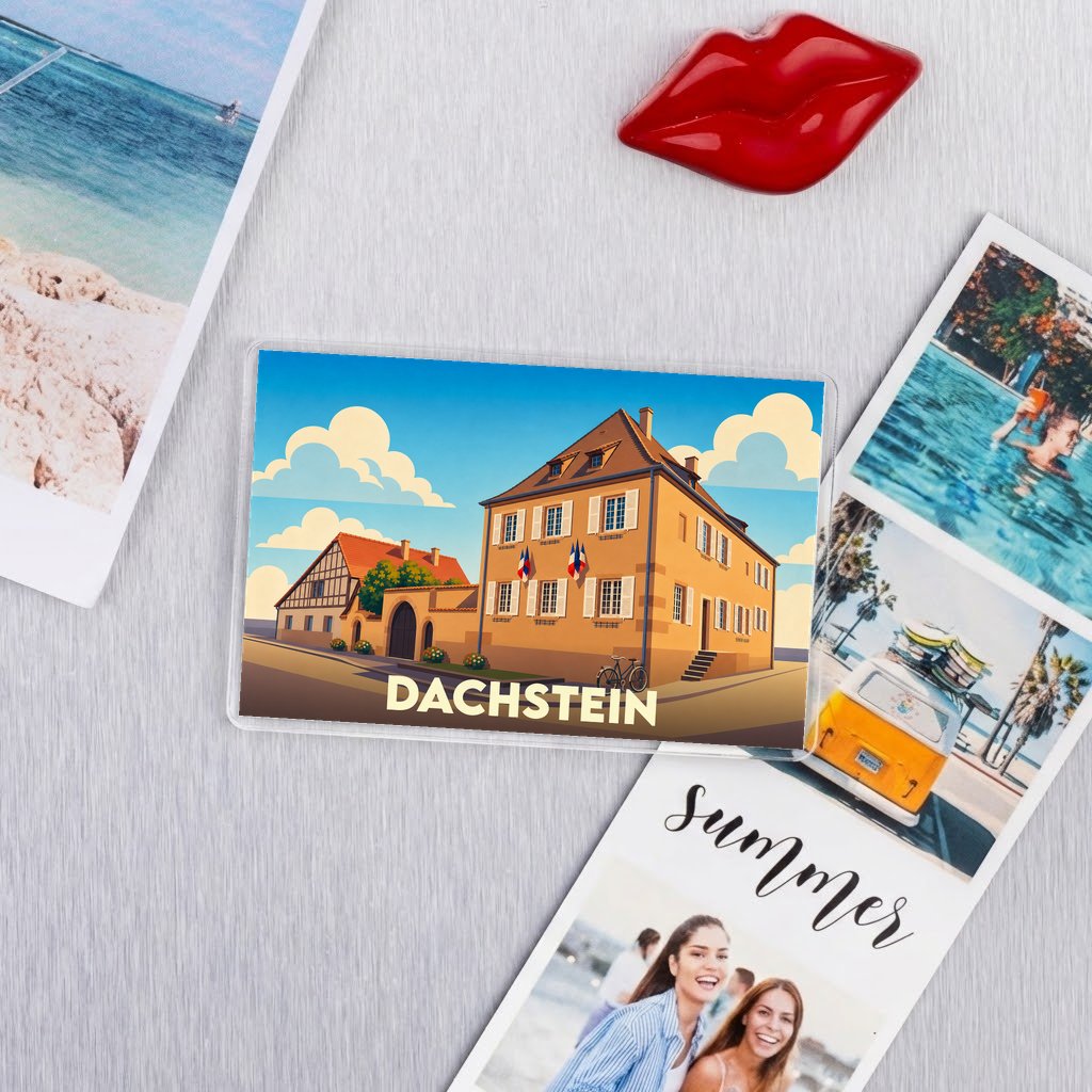Magnet souvenir de la ville de Dachstein avec une illustration stylisée de bâtiments locaux.