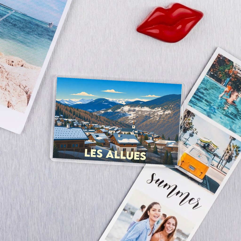 Magnet souvenir de la ville de Les Allues avec une illustration de paysage de montagne enneigé.