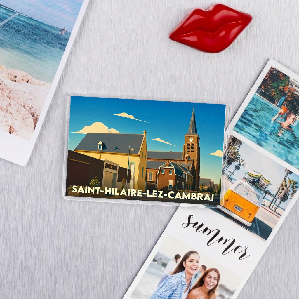Magnet souvenir de la ville de Saint-Hilaire-lez-Cambrai avec une illustration stylisée de son église et de ses bâtiments.