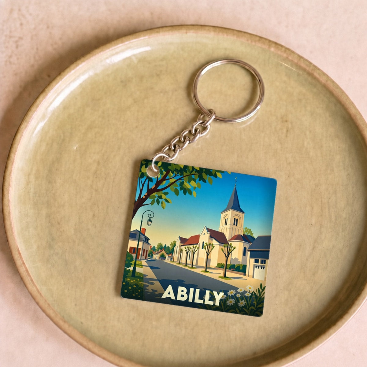 Porte-clés souvenir de la ville d'Abilly avec une illustration stylisée.