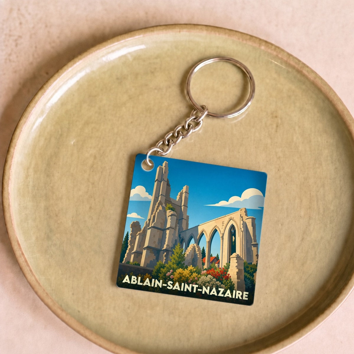Porte-clés souvenir de la ville d'Ablain-Saint-Nazaire avec une illustration stylisée des ruines de l'église.