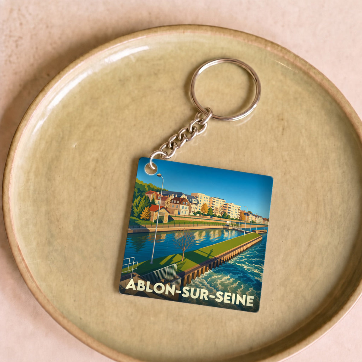 Porte-clés souvenir de la ville de Ablon-sur-Seine avec une illustration colorée et stylisée des bords de Seine.