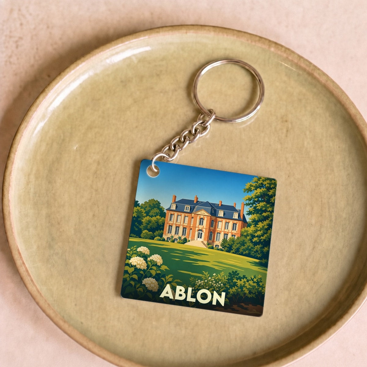 Porte-clés souvenir de la ville d'Ablon avec une illustration stylisée d'un château.