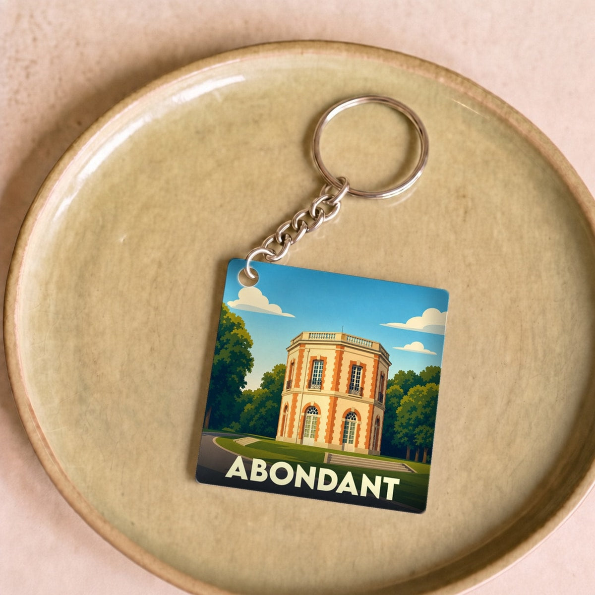 Porte-clés souvenir de la ville d'Abondant avec une illustration stylisée de son château.