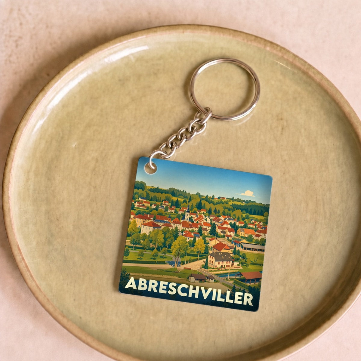 Porte-clés souvenir de la ville d'Abreschviller avec une illustration stylisée.