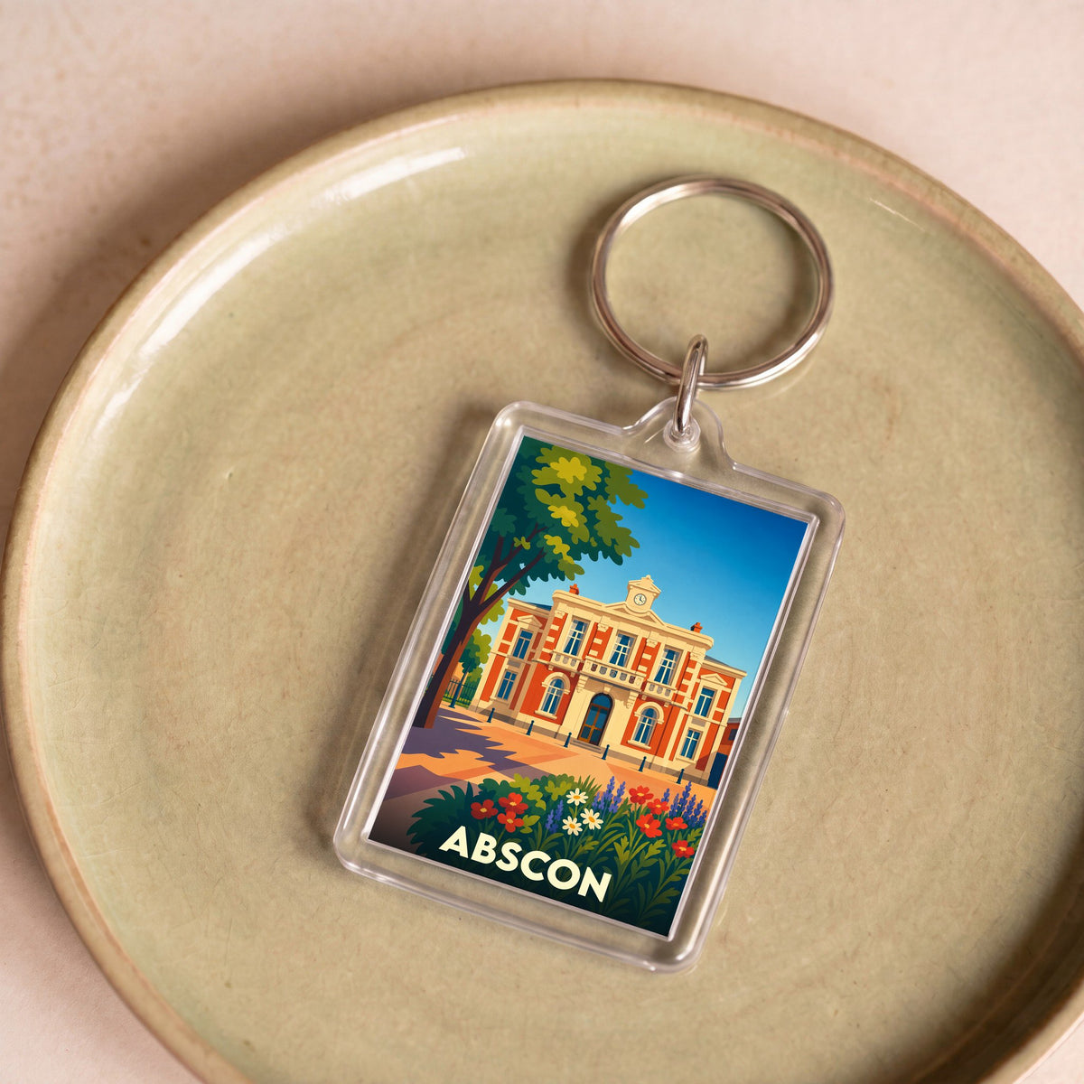 Porte-clés souvenir de la ville d'Abscon avec une illustration colorée et stylisée de son hôtel de ville.