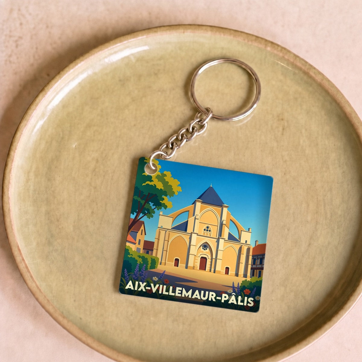Porte-clés souvenir de la ville de Aix-Villemaur-Pâlis avec une illustration stylisée.