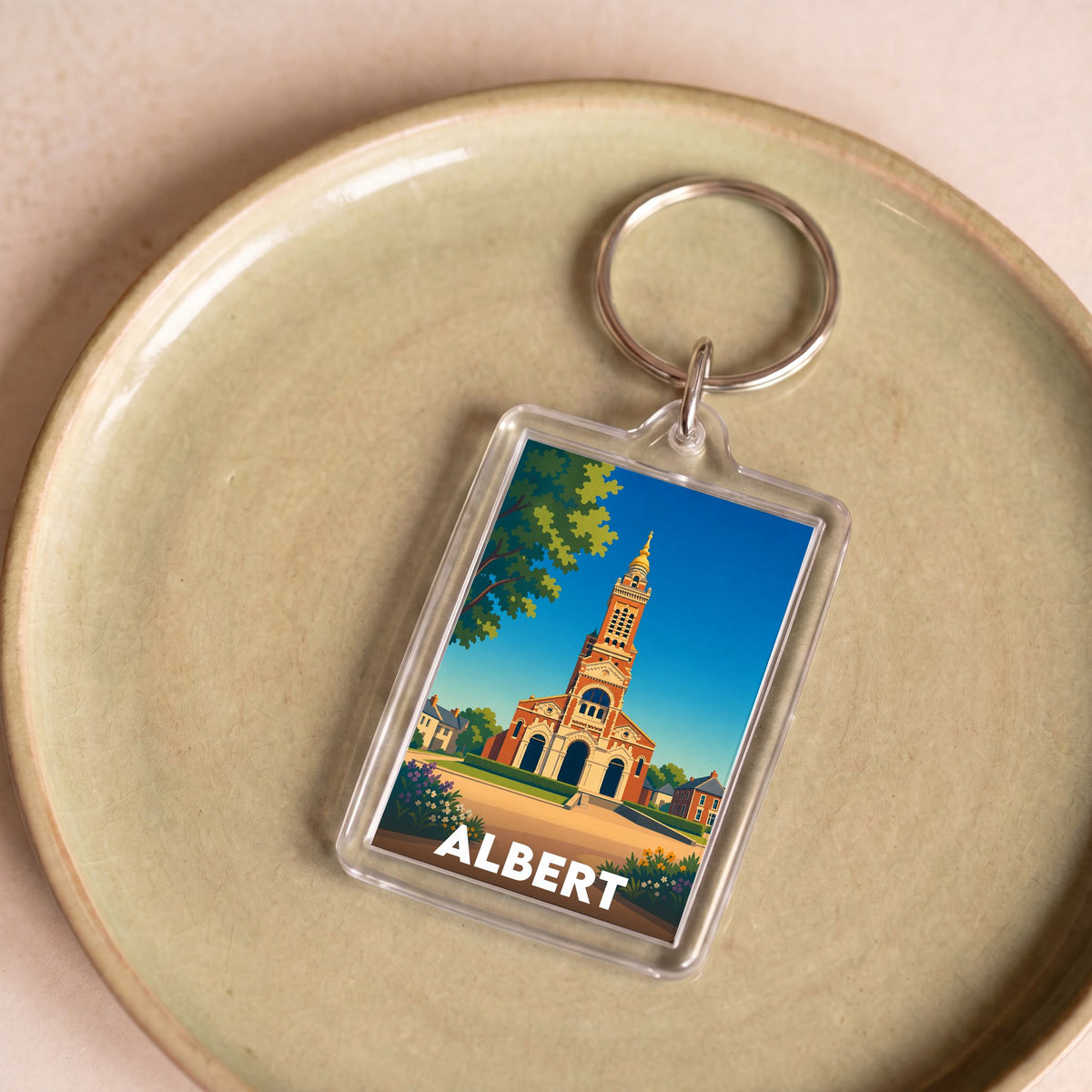 Porte-clés souvenir de la ville d'Albert avec une illustration stylisée de sa basilique.