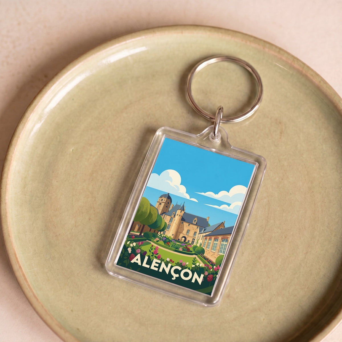 Porte-clés souvenir de la ville d'Alençon avec une illustration stylisée.