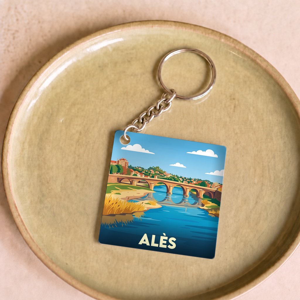 Porte-clés souvenir de la ville d'Alès avec une illustration stylisée.