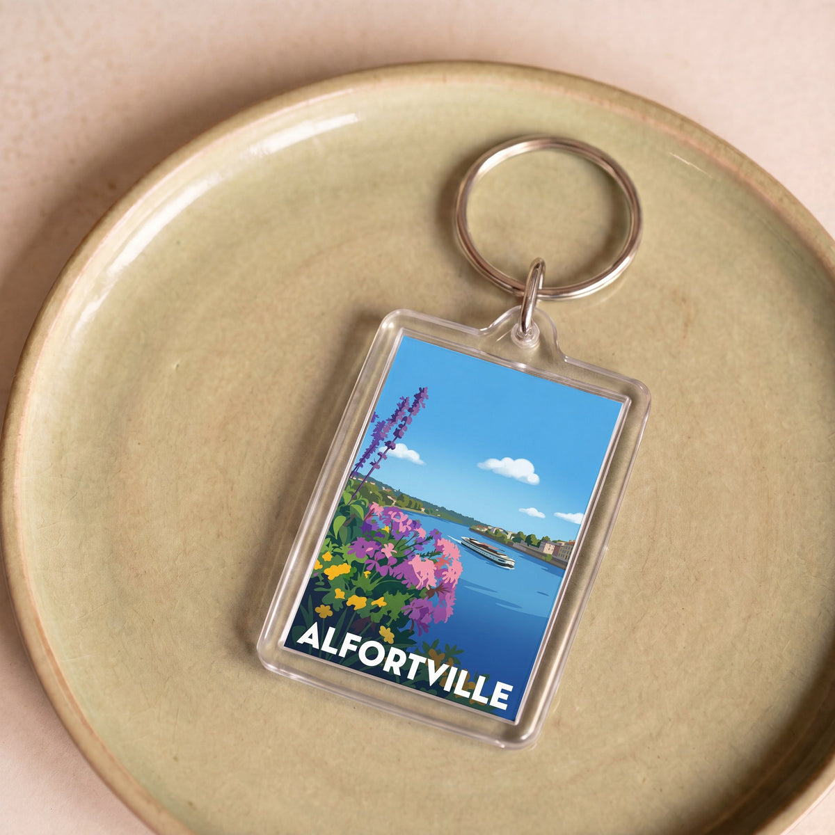 Porte-clés souvenir de la ville d'Alfortville avec une illustration stylisée.