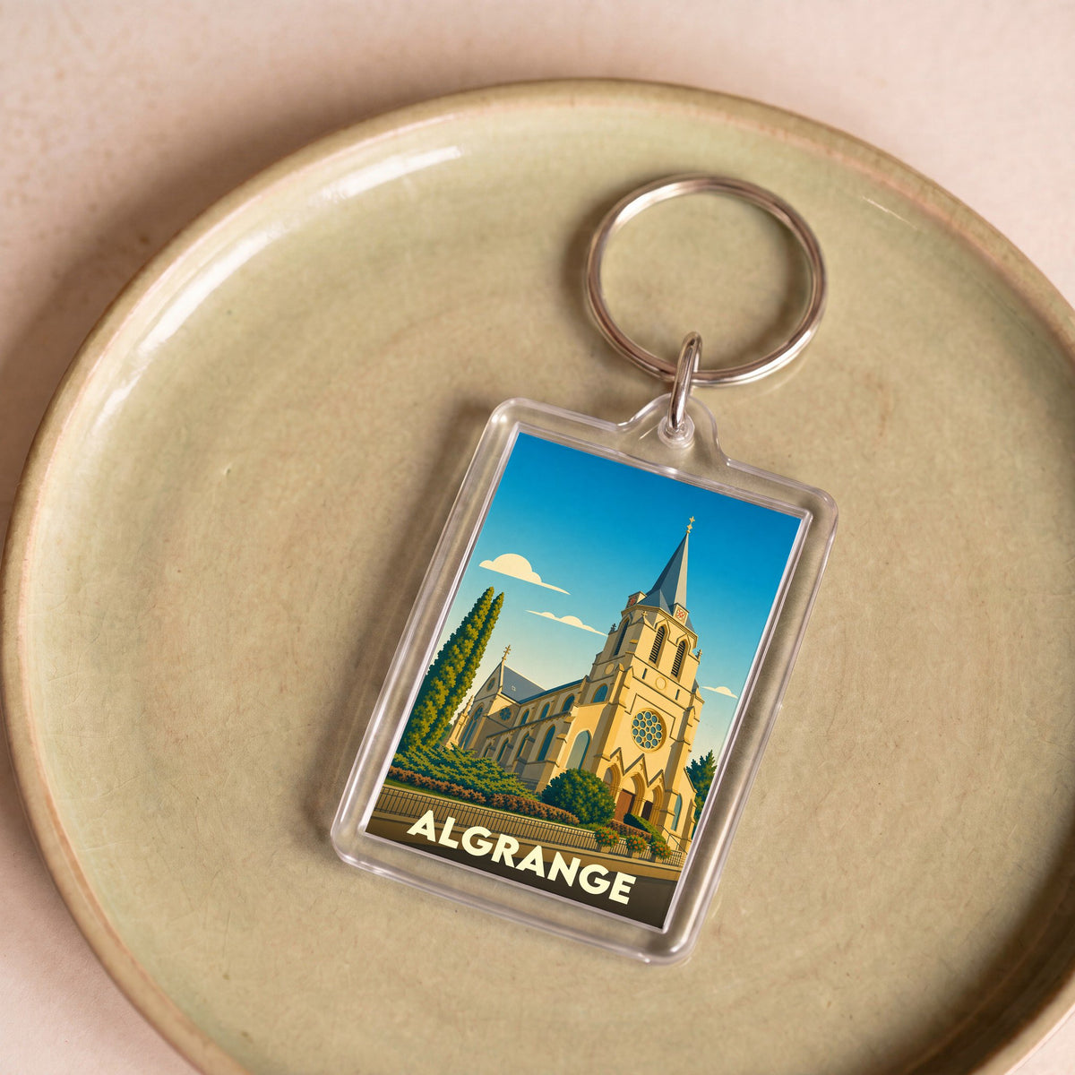 Porte-clés souvenir de la ville d'Algrange avec une illustration stylisée de son église.
