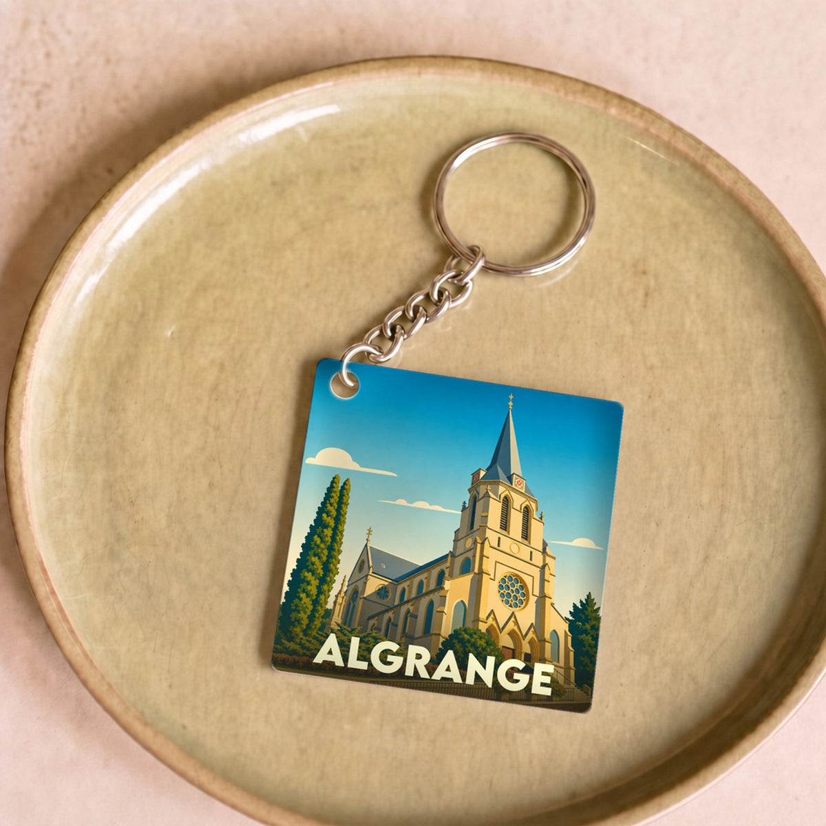Porte-clés souvenir de la ville d'Algrange avec une illustration stylisée de son église.