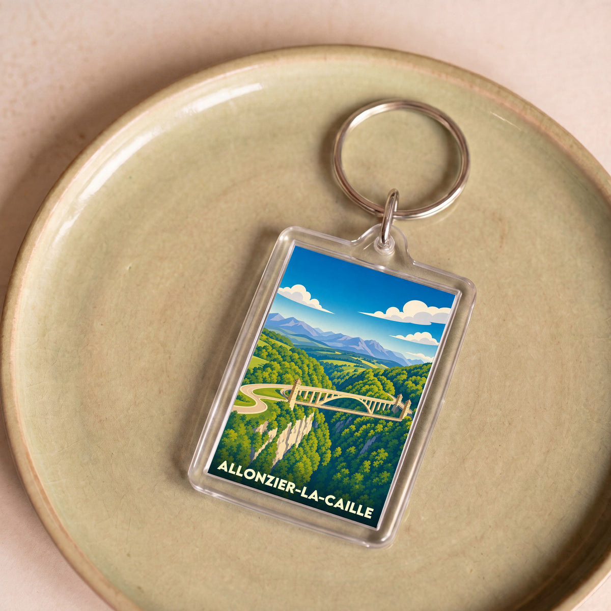 Porte-clés souvenir de la ville de Allonzier-la-Caille avec une illustration stylisée de son célèbre pont.