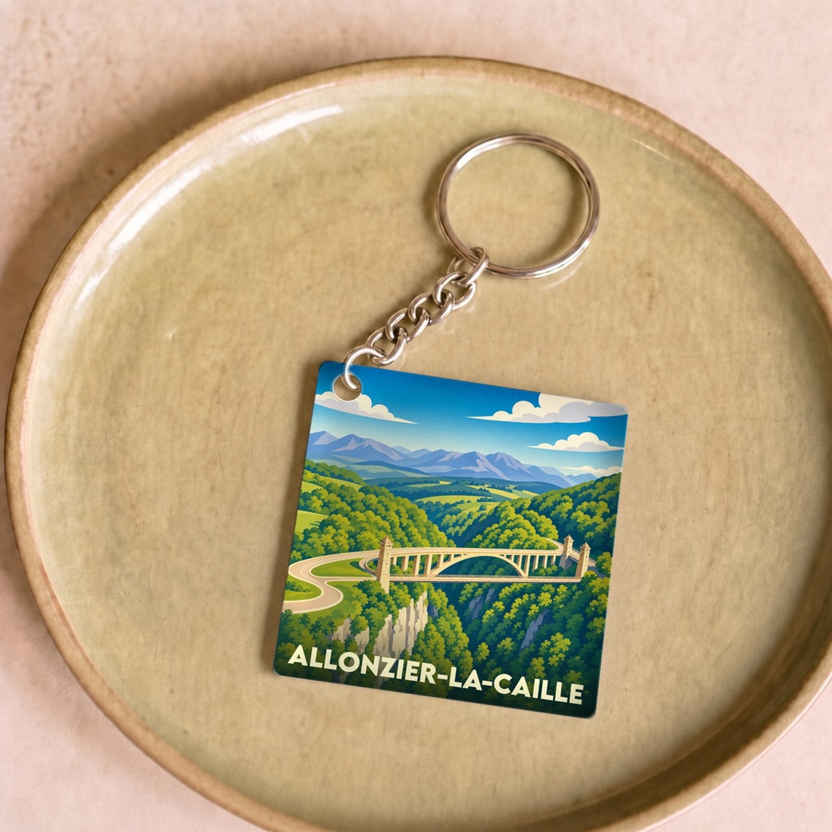 Porte-clés souvenir de la ville de Allonzier-la-Caille avec une illustration stylisée de son célèbre pont.