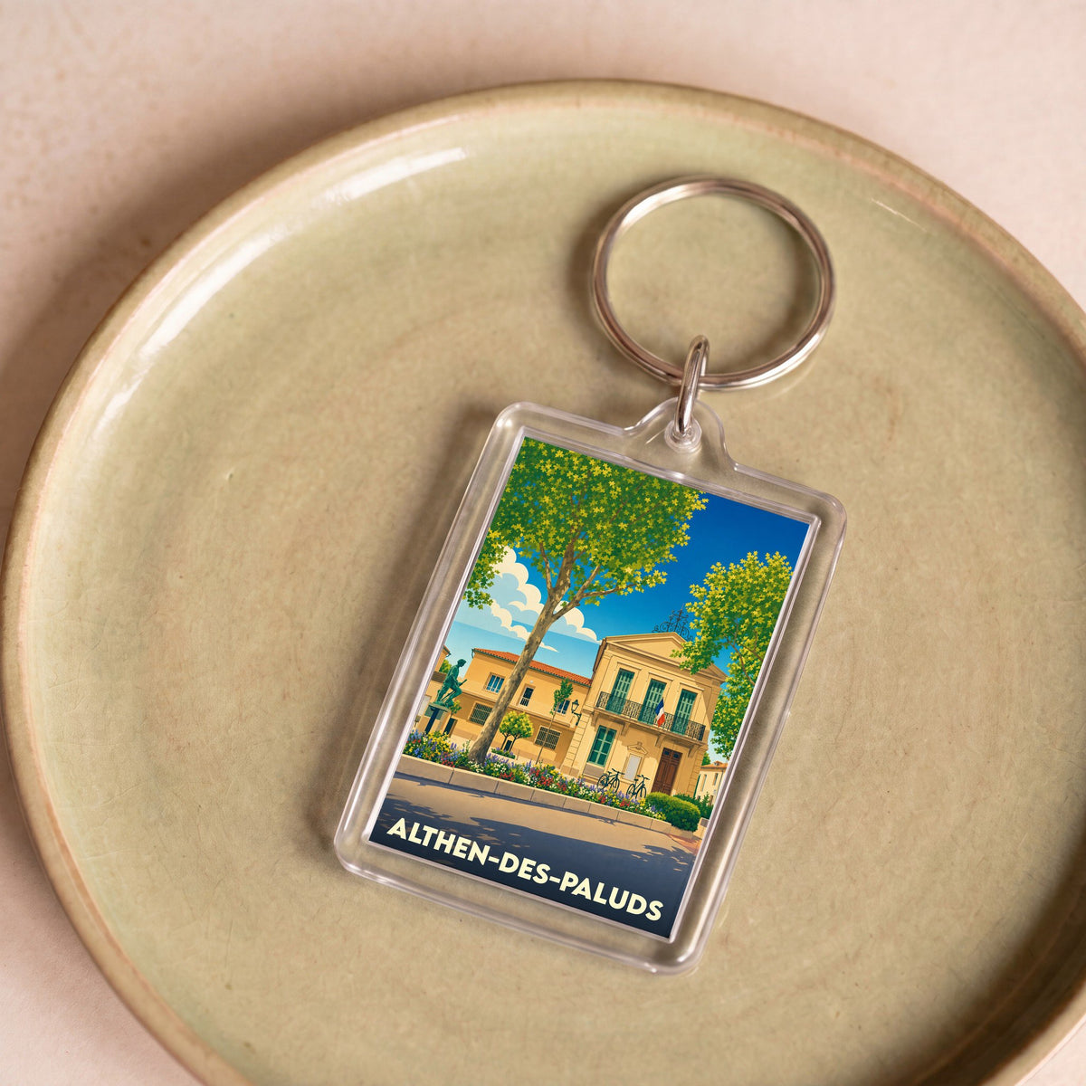 Porte-clés souvenir de la ville d'Althen-des-Paluds avec une illustration stylisée.
